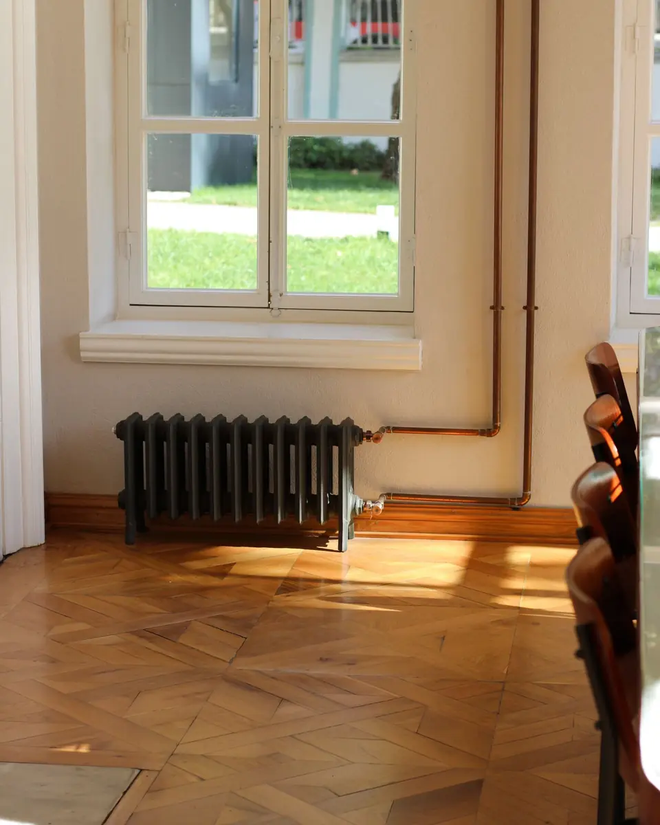 Sunlit room with a cast-iron radiator under the window